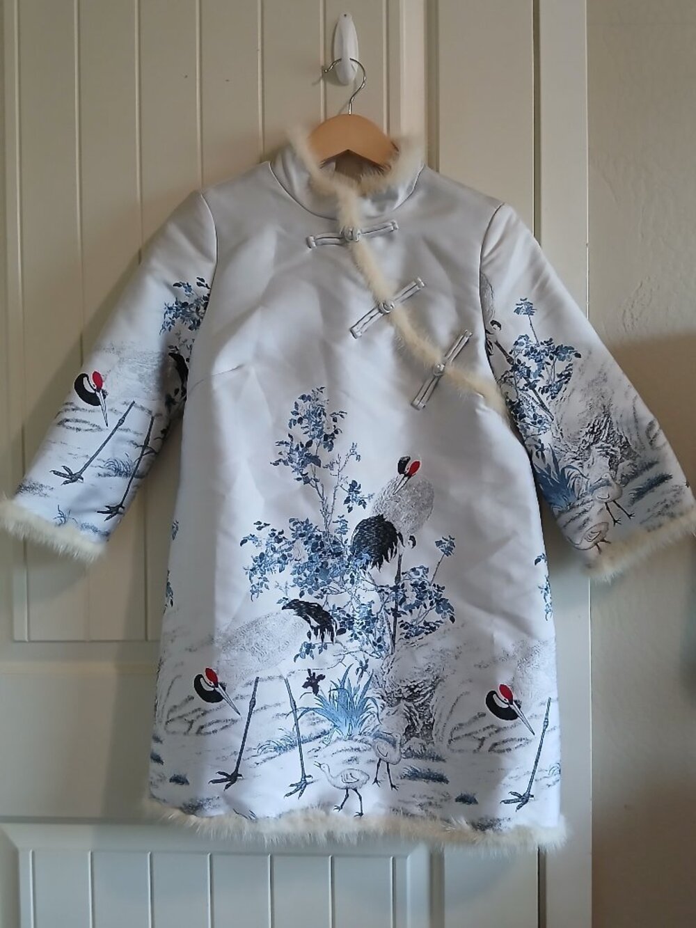 A white coat featuring a crane design
